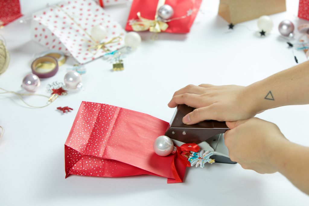 Zur Befestigung der Tüten müssen diese noch gelocht werden, anschließend könnt ihr durch das Loch das Band fädeln und die Tüten an den Ästen festknoten.