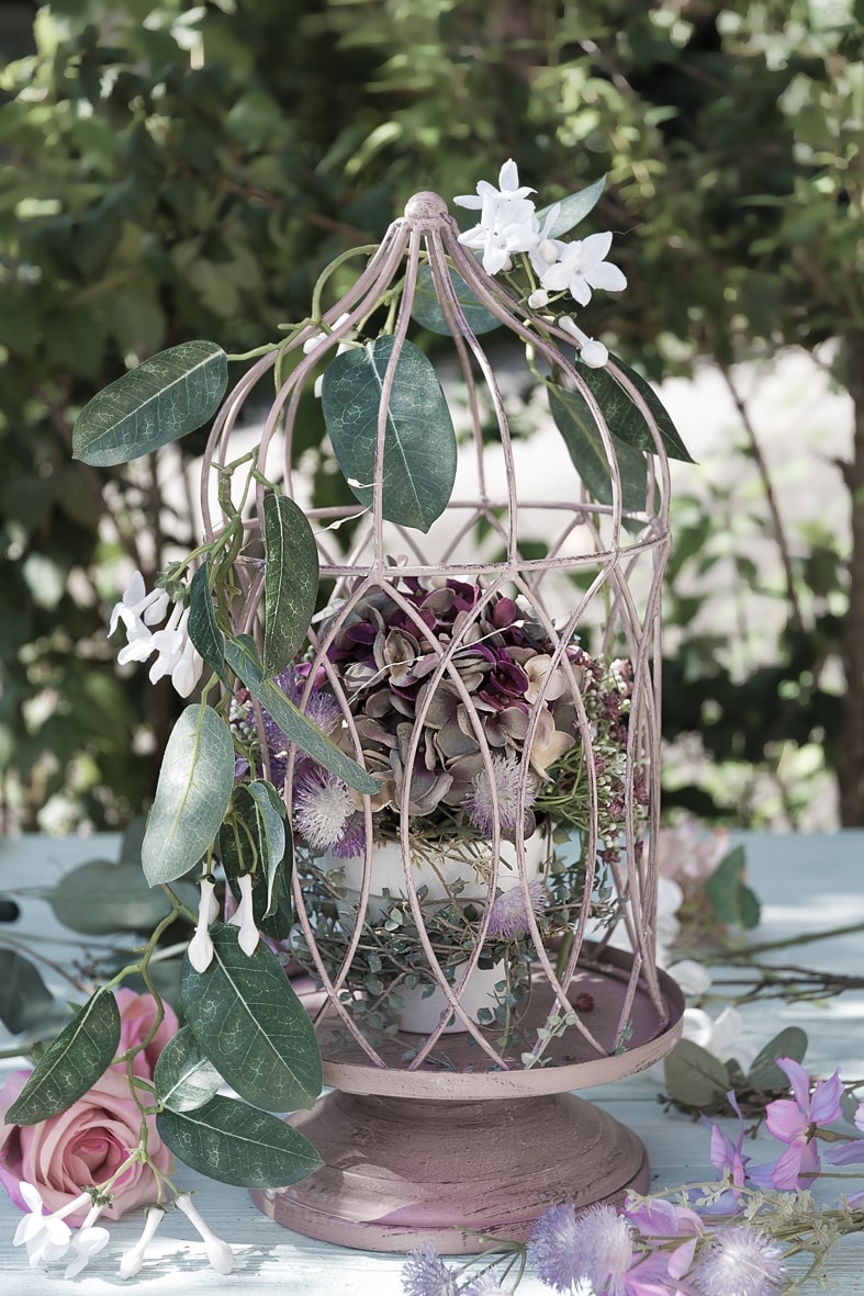 Dekokäfig mit Blütenzweig dekorieren